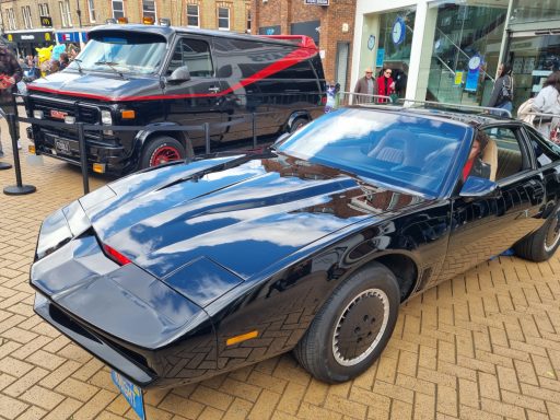 Chelmsford Takeover - KITT and the A Team Van Black classic sports car parked next to a black van with red accents.